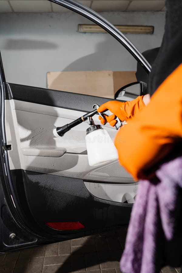 Cleaner Is Washing Car Door Card Panel And Spraying Detergent From