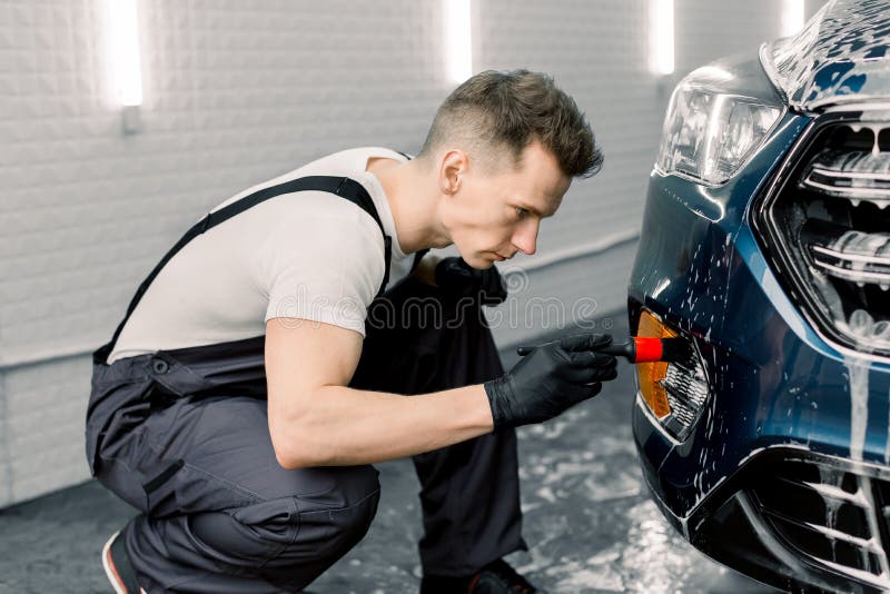 Detailing don. Детейлинг это болезнь. Professional car Wash worker is washing client's car.