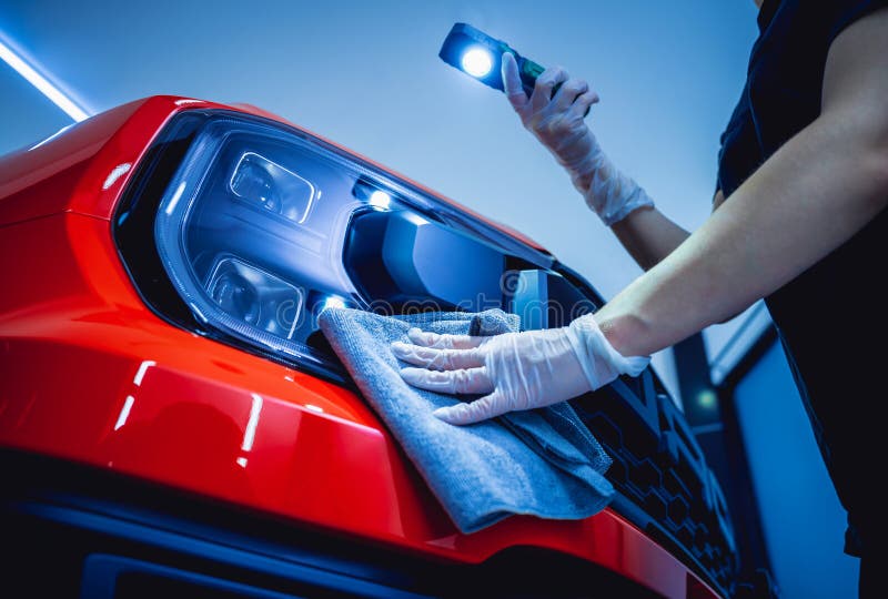 Car Detailing Worker Cleaning and Polishing Car with Microfiber Cloth