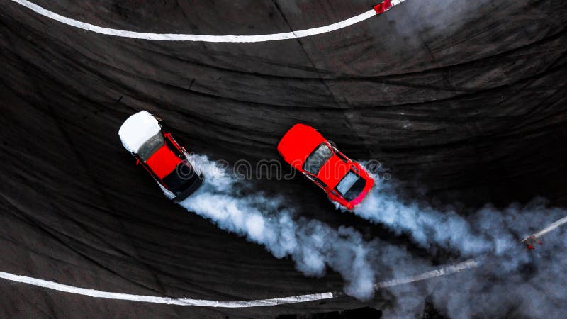 Car drift battle, Two car drifting battle on race track with smoke, Aerial view