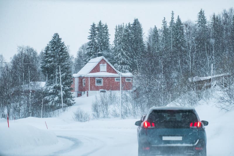 Car Driving in Blizzard with Red House in Countryside on Winter Stock ...