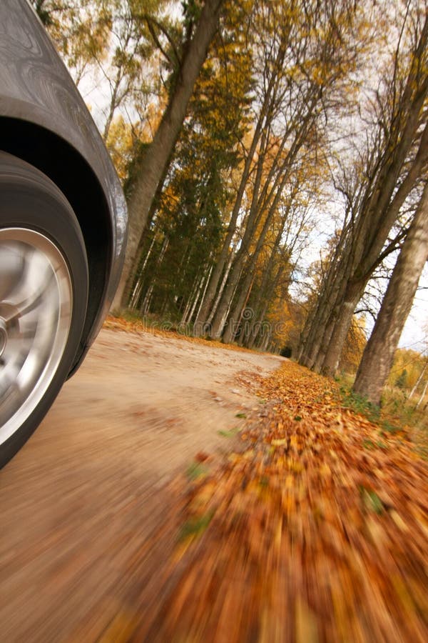 Car driving on country road.