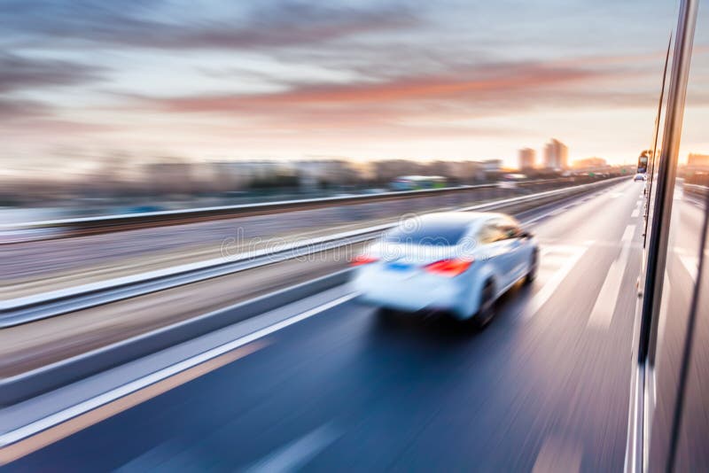 Car driving on freeway at sunset, motion blur