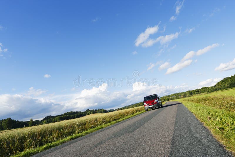 Car, suv, driving along on a lonely narrow country-road, summer, green fields and meadows. sweden. Car, suv, driving along on a lonely narrow country-road, summer, green fields and meadows. sweden