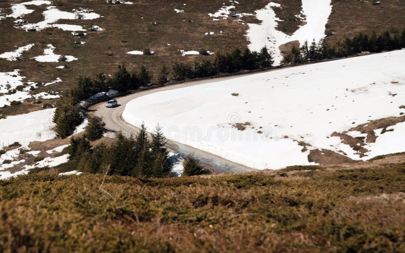 Car driving on narrow road in Beklemeto pass, Balkan mountains, Bulgaria. Melting snow in spring time, dangerous driving condition stock photo Car driving on narrow road in Beklemeto pass, Balkan mountains, Bulgaria. Melting snow in spring time, dangerous driving condition stock photo