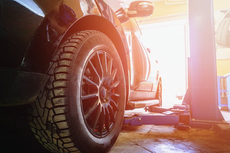 Car in garage of auto repair service with special repairing. Car in garage of auto repair service shop with special repairing equipment stock photography Car in garage of auto repair service with special repairing. Car in garage of auto repair service shop with special repairing equipment stock photography