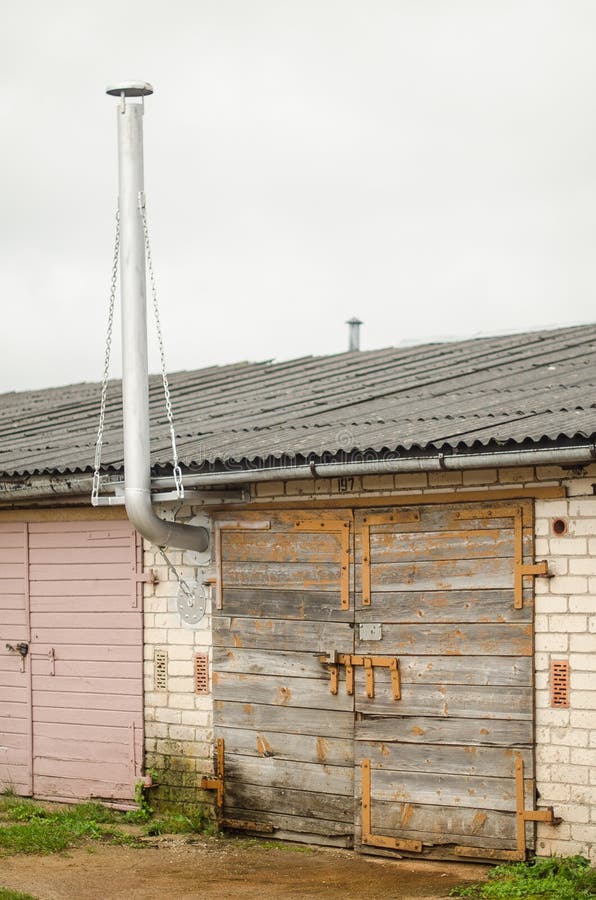 Car garages with large chimney, Kuldiga, Latvia royalty free stock image