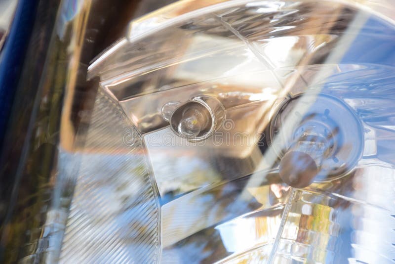Car Headlight Close Up with Bulbs Visible through Glass Stock Photo