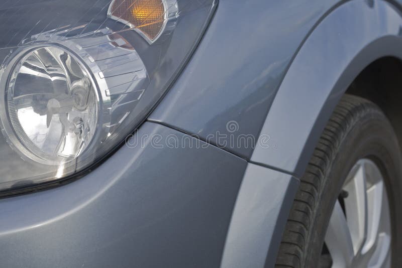 Car headlights and tyre in a close up