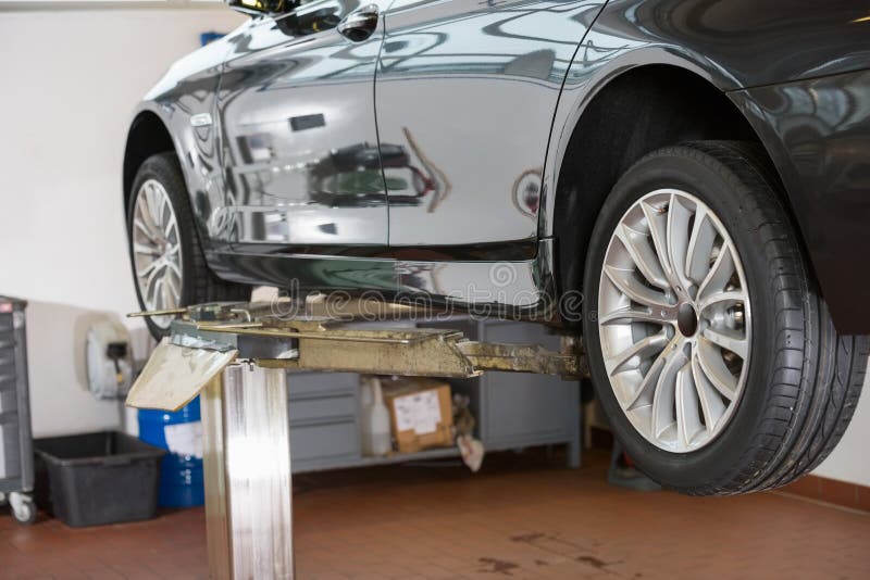 Car on Hoist at Repair Shop Stock Photo Image of maintaining, wheel