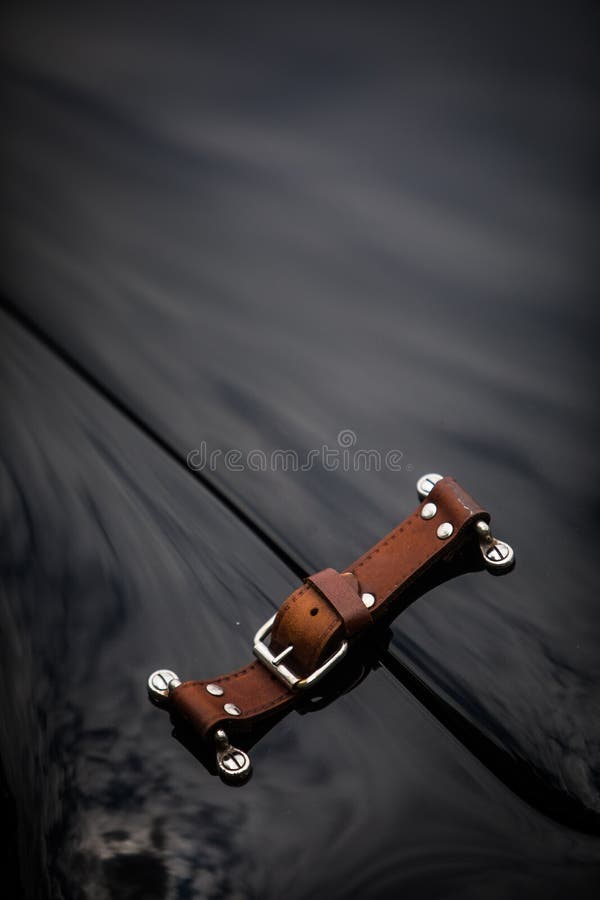 Car hood and leather strap stock photo. Image of design 174122730