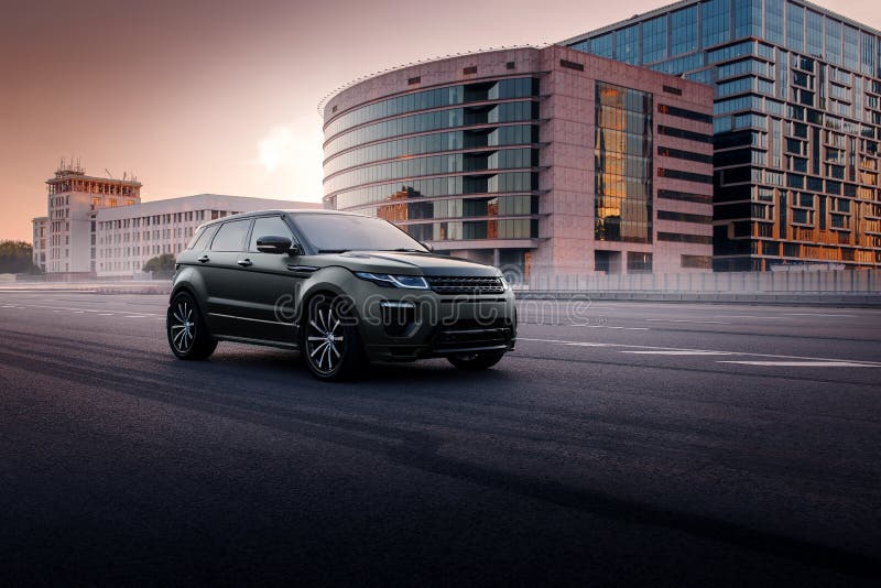 Car Land Rover Range Rover Evoque standing on asphalt road in city Moscow at sunset