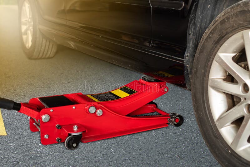 Hydraulic Car Jack To Lift Car For Change The Wheel Stock Image