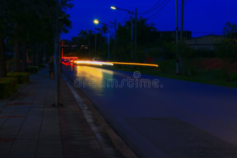 Car Lights at Night in City and Headlights. Long Exposure with Copy