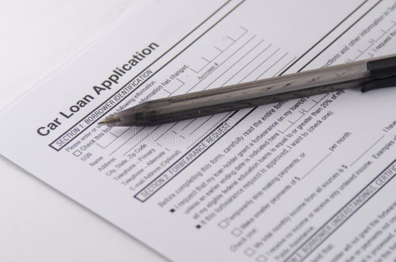 A car loan application form, sheet of paper with a black pen. Shallow depth of field. Focus on words on paper.