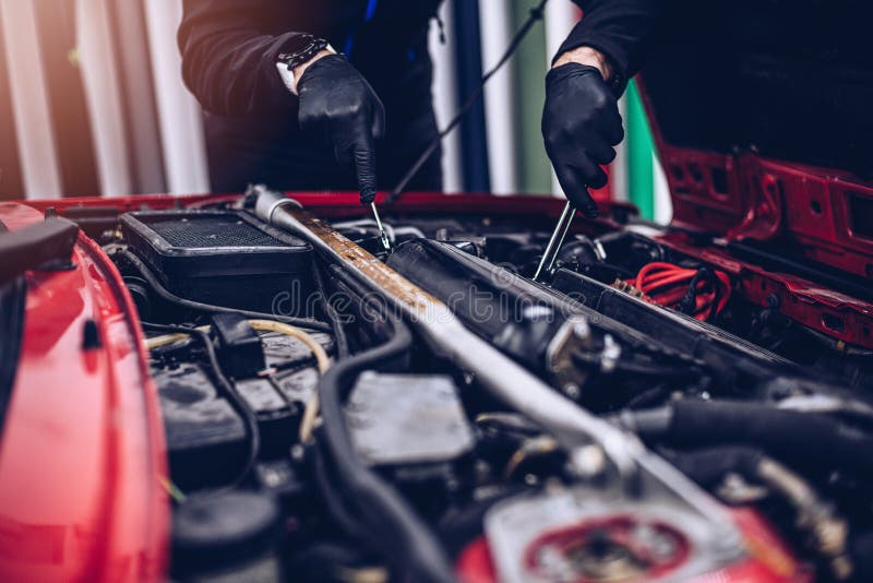 Car Mechanic Repairing Customer Engine with Wrench. Stock Image Image