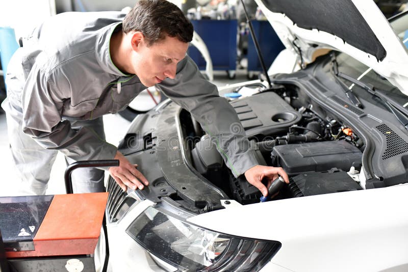 Car Mechanic in a Engine Repair and Diagnosis on a Vehicle