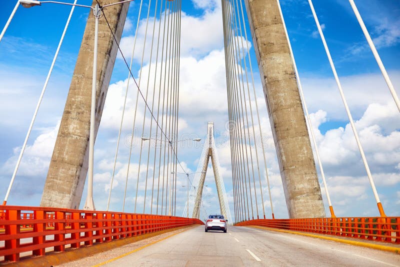 Car is moving through the beautiful bridge. The Francisco del Rosario Sánchez Bridge over the Ozama river in Santo Domingo royalty free stock photo Car is moving through the beautiful bridge. The Francisco del Rosario Sánchez Bridge over the Ozama river in Santo Domingo royalty free stock photo