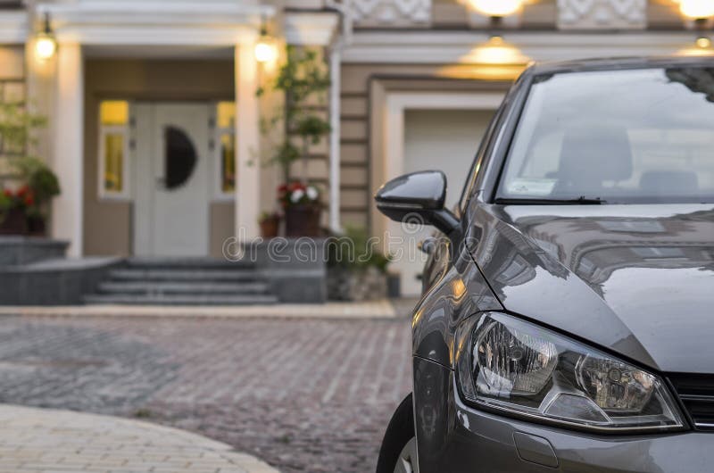 Car is parked near house stock image. Image of paving 96776303