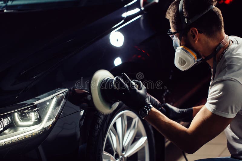 Car polish wax. worker hands holding a polisher