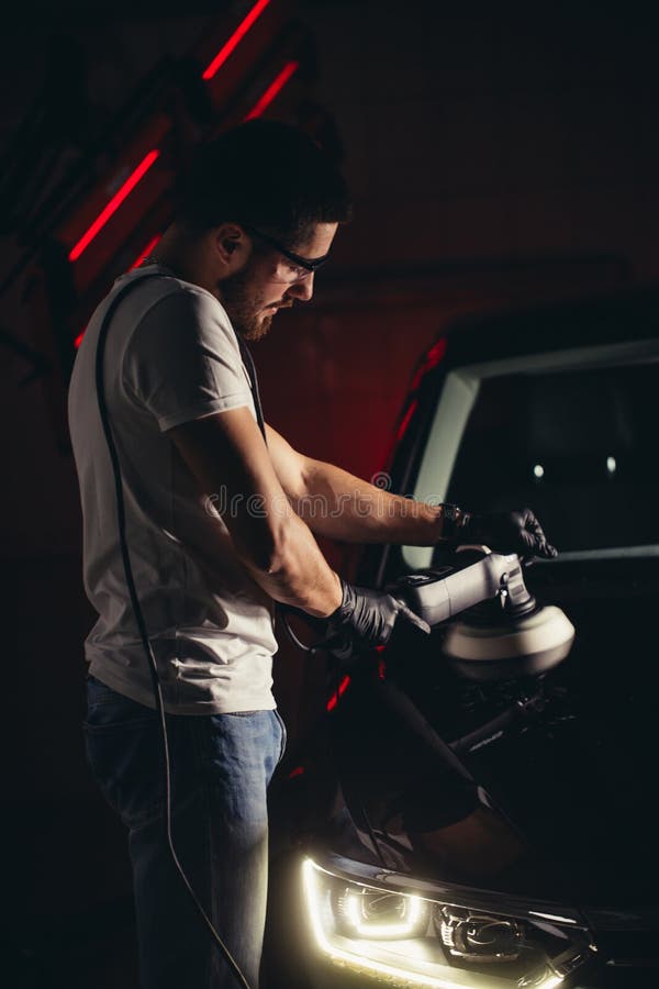 Car polish wax. worker hands holding a polisher