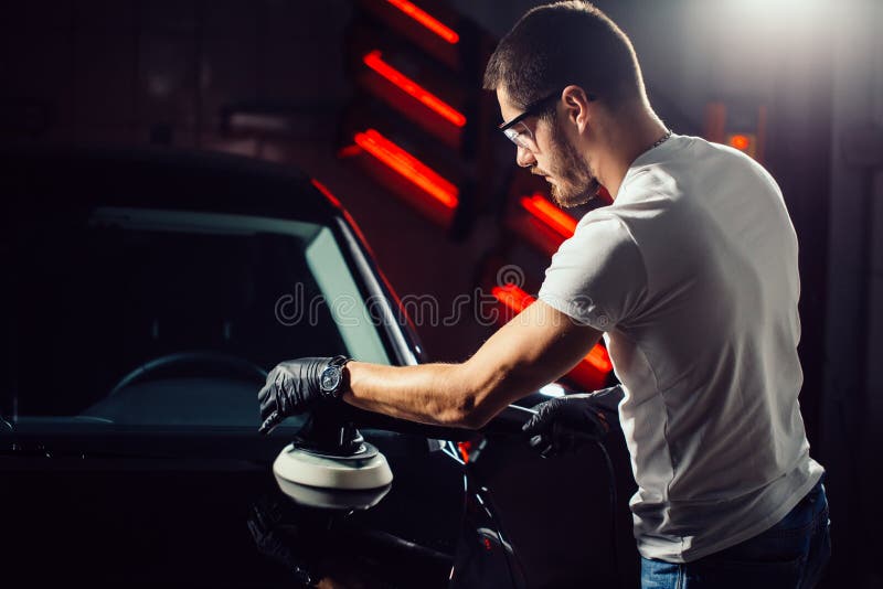 Car polish wax. worker hands holding a polisher stock photography Car polish wax. worker hands holding a polisher stock photography