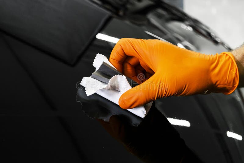 Car polish wax worker hands polishing car. Buffing and polishing vehicle. Car detailing. Man holds a polisher in the hand and poli