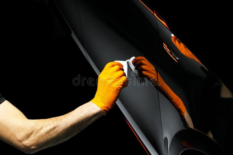 Car polish wax worker hands polishing car. Buffing and polishing vehicle with ceramic. Car detailing. Man holds a polisher in the