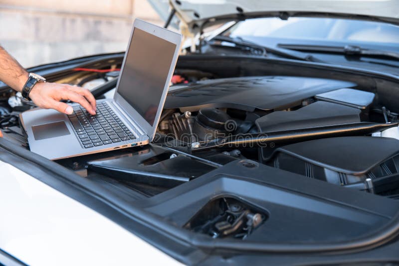 Car repair with computer stock photo. Image of maintenance 223719584