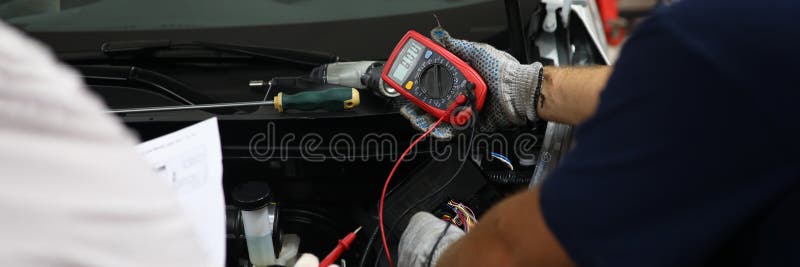 Premium Photo  Auto service, repair and maintenance concept - digital  multimeter or voltmeter testing car battery.