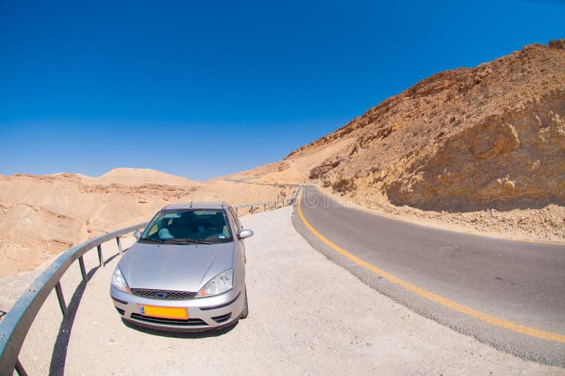 Car on the road in the desert royalty free stock images