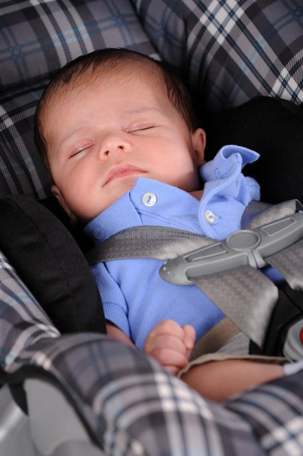 A newborn sleeping peacefully in his car seat. A newborn sleeping peacefully in his car seat.