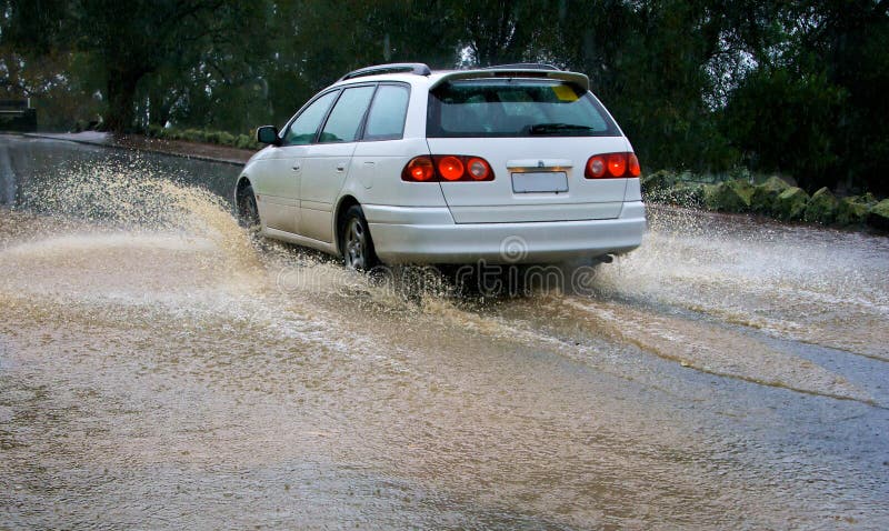 Car driving through a puddle. Car driving through a puddle