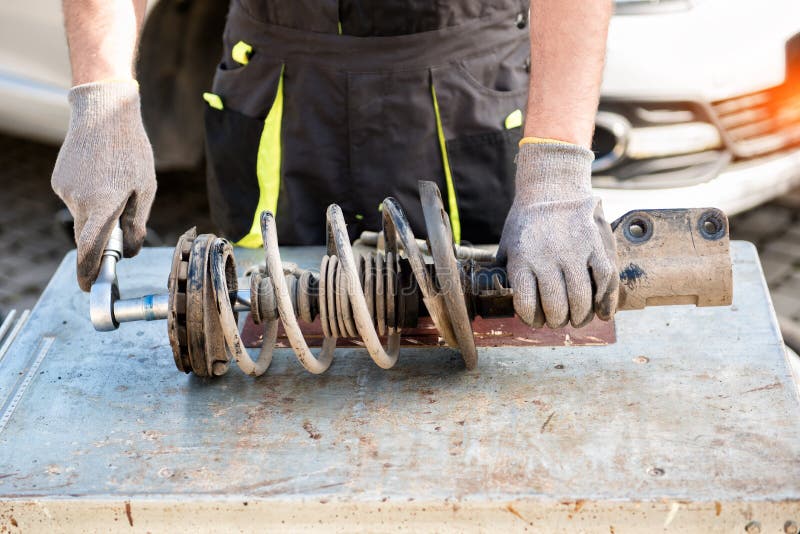 Car Suspension Repair in the Back of a SUV on a Lift with a Wheel
