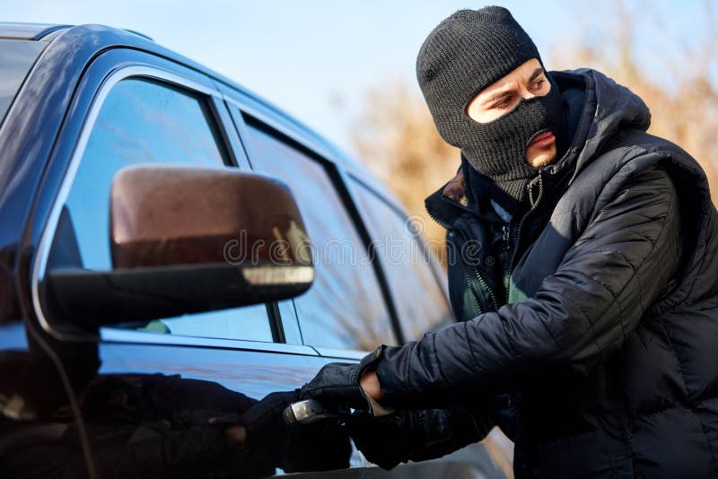 Car thief in car theft on car door