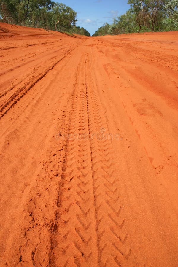 Red Australian rural road with car tracks in dirt. Red Australian rural road with car tracks in dirt.