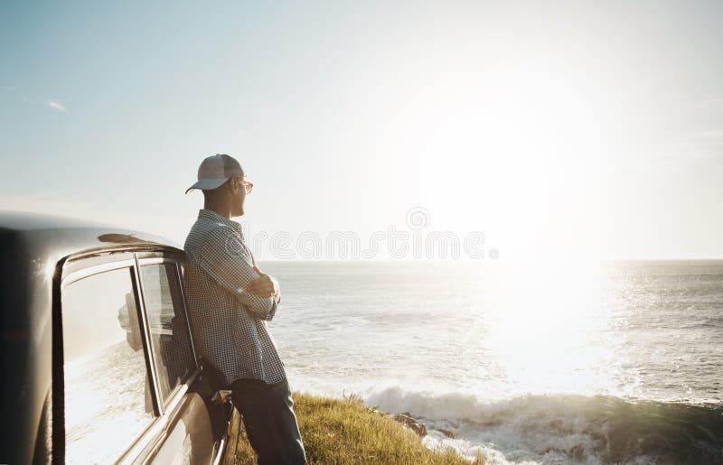 Car, travel and man with view of ocean for summer vacation, journey and thinking in sunshine. Holiday, relax and person royalty free stock image