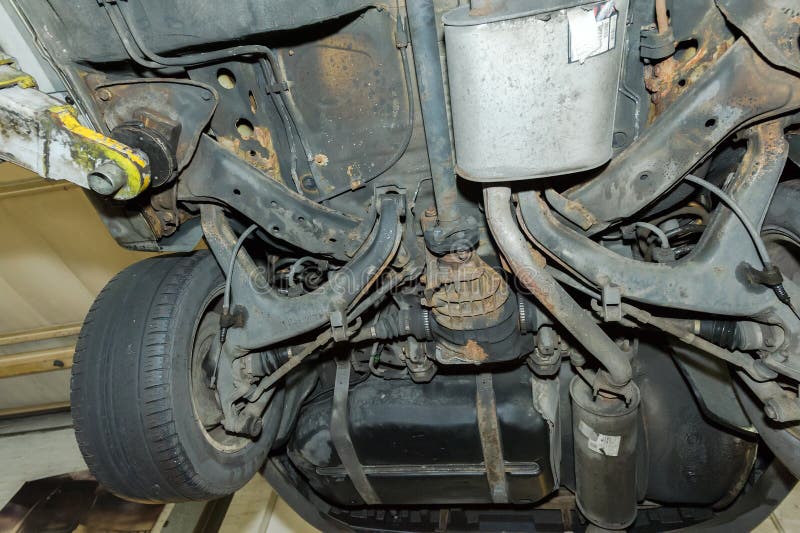 Undercarriage Of A Car In Garage. Vehicle Maintenance In Auto Re Stock