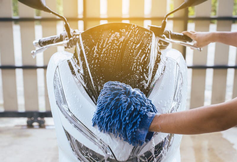 Car wash,Hand men cleaning motorcycle wash foam water at home stock photography Car wash,Hand men cleaning motorcycle wash foam water at home stock photography