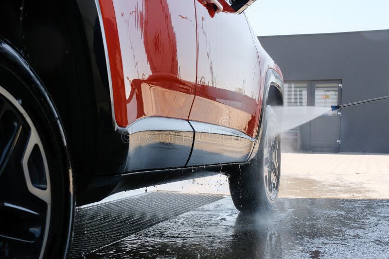 Car Wash with High Pressure Water. Car in Foam, Car Wash Stock Photo