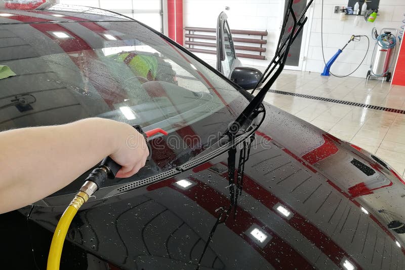 Car Wash Worker Blows the Front of the Car with Compressed Air. Stock Image Image of wheel