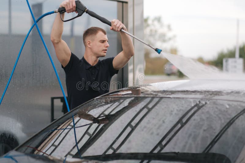 Cleaning car using active foam. Man washing his car on self car-washing  Stock Photo - Alamy