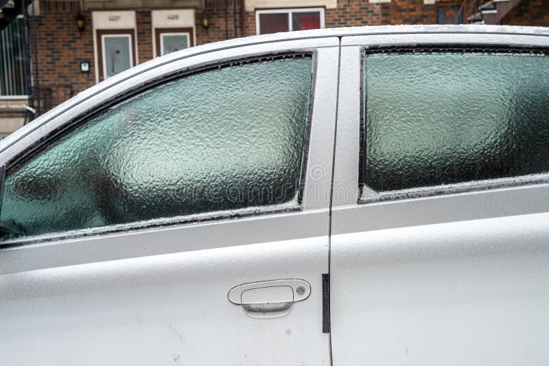 Car Windows are Covered with Ice after Freezing Rain. Stock Photo