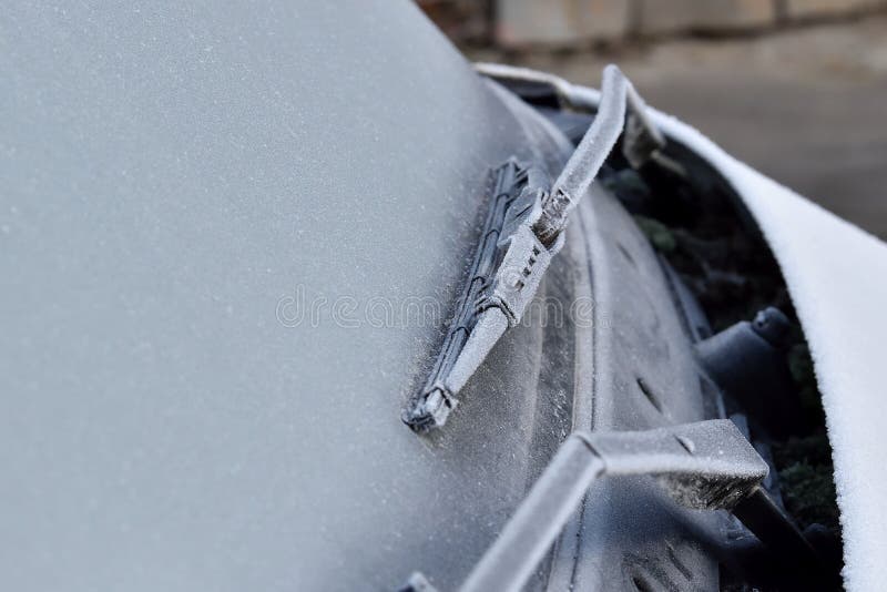 Car Wiper and Front Window Covered with Frost, Frosted Rubber on Glass