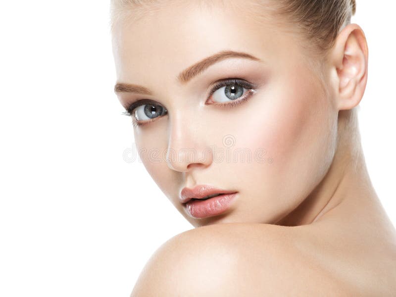 Beautiful face of young caucasian woman with perfect health fresh skin - isolated on white. Skin care concept. Beautiful face of young caucasian woman with perfect health fresh skin - isolated on white. Skin care concept.