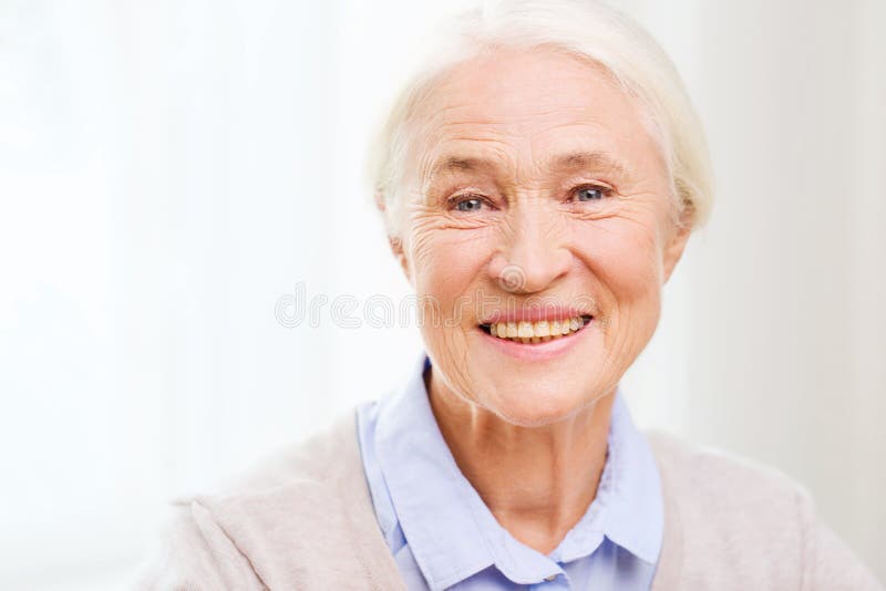 Cara mayor feliz de la mujer en casa fotografía de archivo libre de regalías Cara mayor feliz de la mujer en casa fotografía de archivo libre de regalías