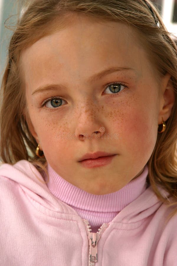 Face of a young girl with fair skin and freckles. Face of a young girl with fair skin and freckles.