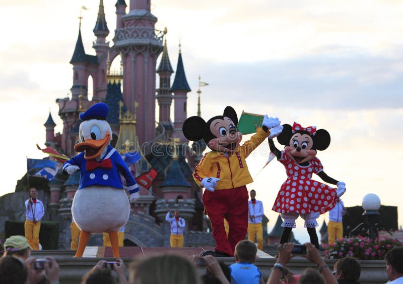 Disney characters (Mickey Mouse, Donald Duck and Minnie Mouse) performing on a stage in front of the Princesses Castle in Disneyland Paris. Disney characters (Mickey Mouse, Donald Duck and Minnie Mouse) performing on a stage in front of the Princesses Castle in Disneyland Paris.