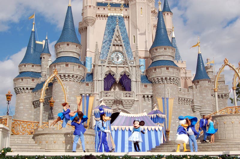 August 2007, Magic Kingdom (Orlando) - Disney characters dancing at Disney Cinderella castle under a blue sky with white clouds. August 2007, Magic Kingdom (Orlando) - Disney characters dancing at Disney Cinderella castle under a blue sky with white clouds