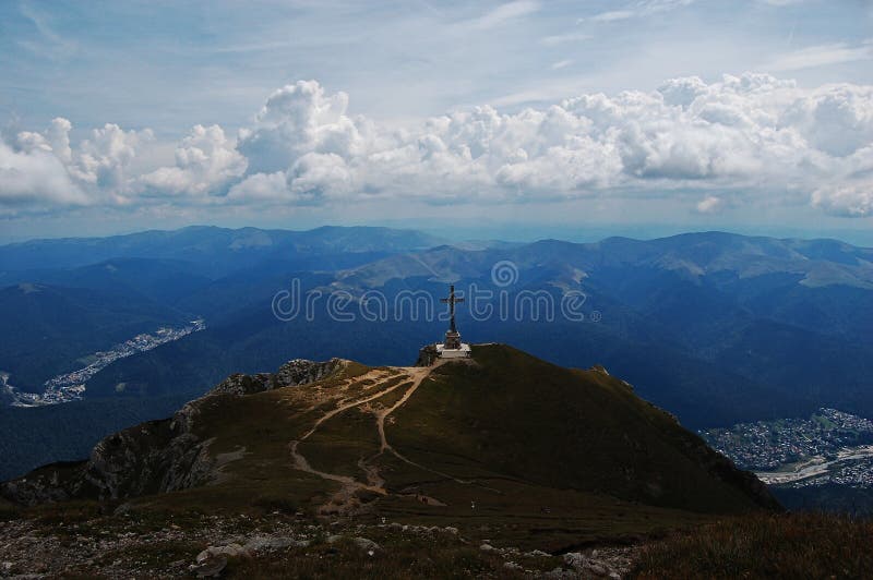 This cross is located in the top of the montain Caraiman (Busteni, Romania), we can see two towns:Busteni(left side) and Sinaia(right side). This cross is located in the top of the montain Caraiman (Busteni, Romania), we can see two towns:Busteni(left side) and Sinaia(right side).